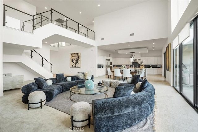 11818 N Hillsborough Ln, Porter Ranch, CA 91326 - living room with a high ceiling, light colored carpet, and stairs