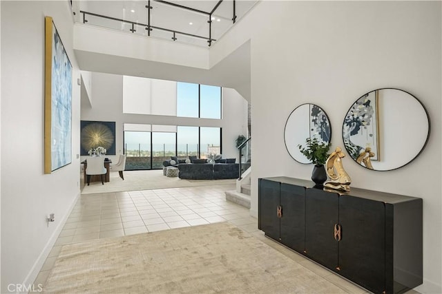 11818 N Hillsborough Ln, Porter Ranch, CA 91326 - hall with a high ceiling, tile patterned floors, baseboards, and track lighting