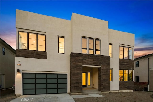 11818 N Hillsborough Ln, Porter Ranch, CA 91326 - view of front of property featuring an attached garage, stone siding, concrete driveway, and stucco siding