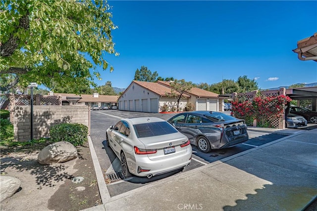 uncovered parking lot featuring a residential view