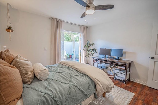 bedroom with baseboards, a ceiling fan, wood finished floors, and access to exterior