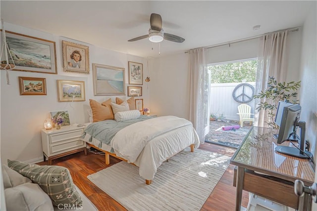 bedroom featuring access to outside, ceiling fan, and wood finished floors