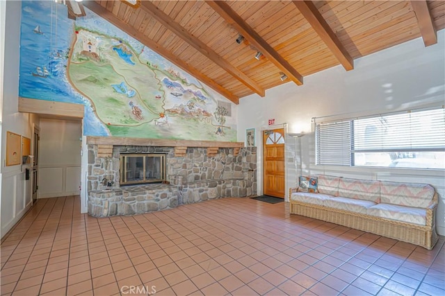 tiled living room featuring beamed ceiling, high vaulted ceiling, wood ceiling, and a fireplace