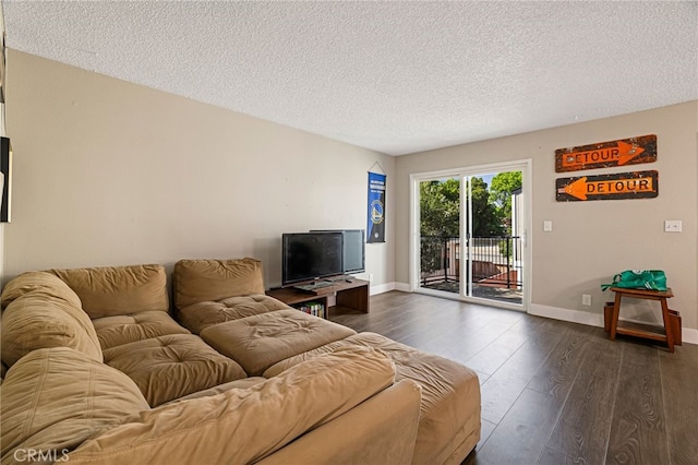 living room featuring a textured ceiling, dark wood finished floors, and baseboards