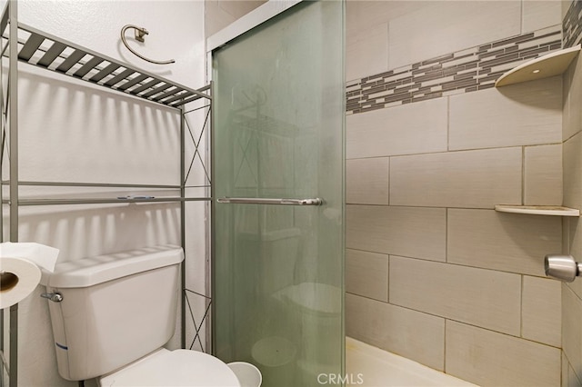 full bath with a stall shower and toilet