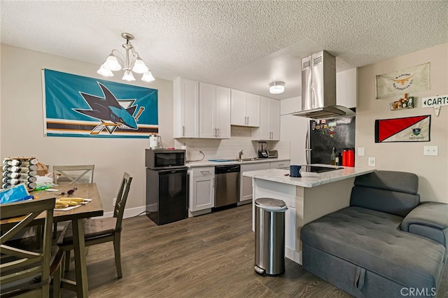 kitchen with a textured ceiling, island exhaust hood, appliances with stainless steel finishes, dark wood finished floors, and a chandelier
