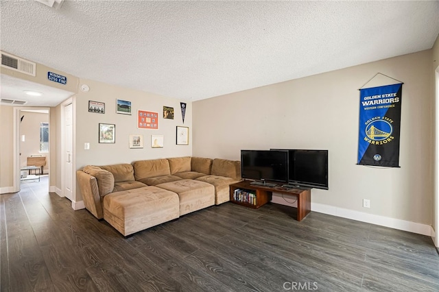 living room with visible vents, a textured ceiling, dark wood-type flooring, and baseboards
