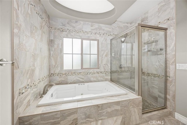 full bath featuring a garden tub and a shower stall