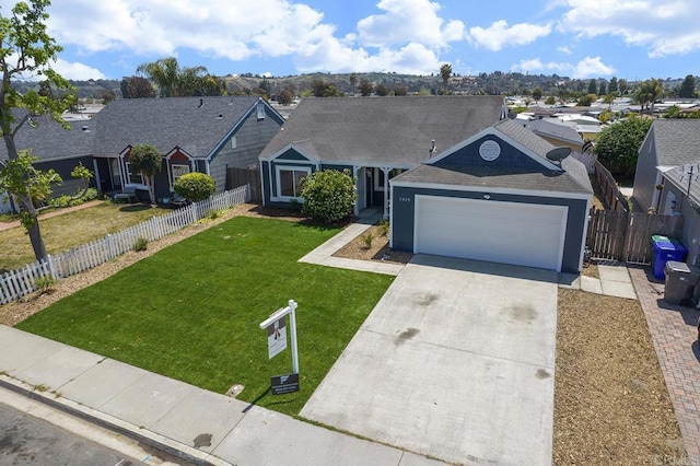 single story home with a garage, driveway, a front lawn, and a residential view