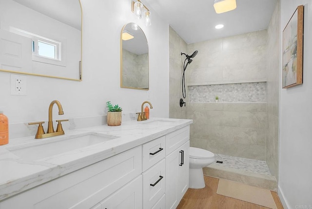 bathroom with double vanity, a sink, and walk in shower