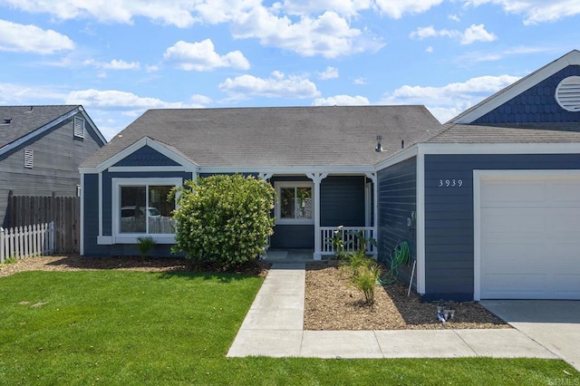 view of front of home with a porch, a front lawn, roof with shingles, and fence