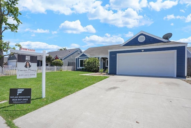ranch-style house featuring fence, a garage, driveway, and a front yard