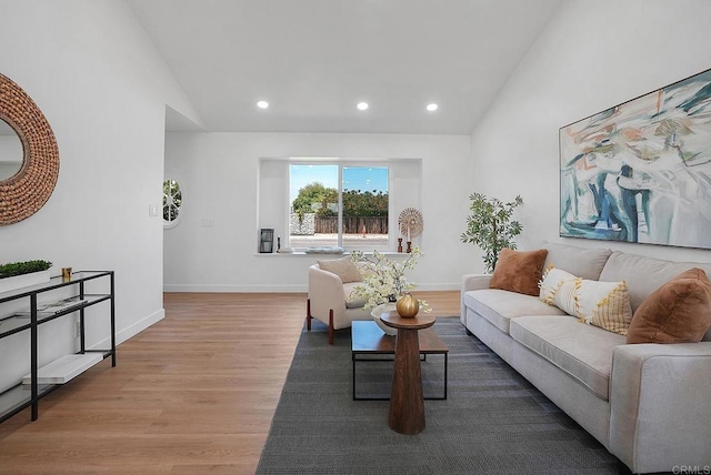 living room featuring baseboards, high vaulted ceiling, recessed lighting, and wood finished floors