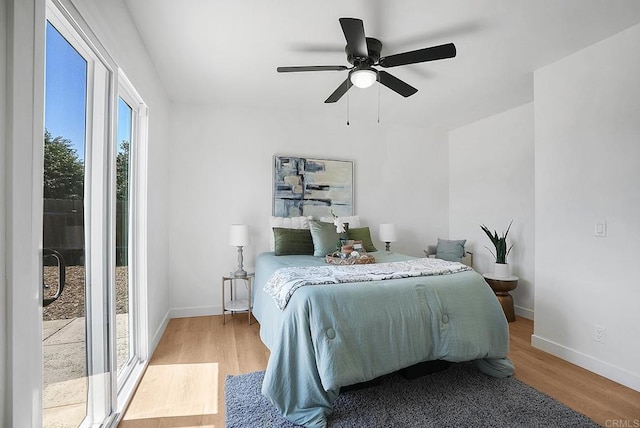 bedroom with baseboards, a ceiling fan, and wood finished floors