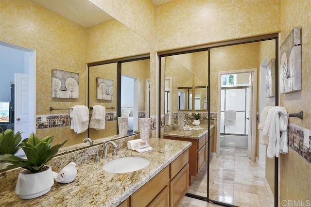 bathroom with shower / bath combination, two vanities, a sink, and marble finish floor