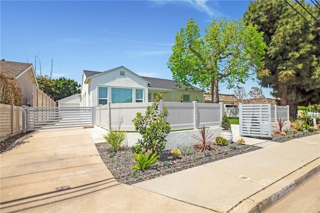 view of front facade featuring stucco siding and fence