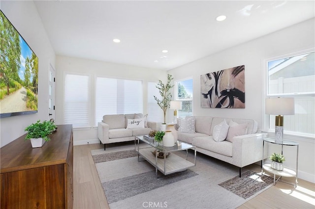 living room featuring recessed lighting, baseboards, and wood finished floors