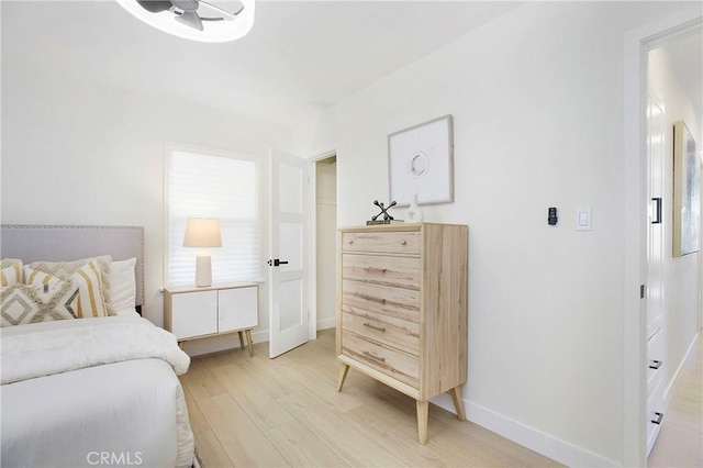 bedroom featuring baseboards and light wood-style flooring