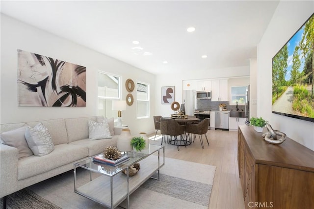 living room featuring light wood-style floors and recessed lighting