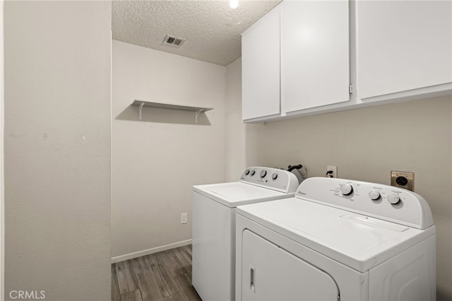 43922 Warner Trl, Palm Desert, CA 92211 - laundry room featuring wood finished floors, separate washer and dryer, cabinet space, a textured ceiling, and baseboards