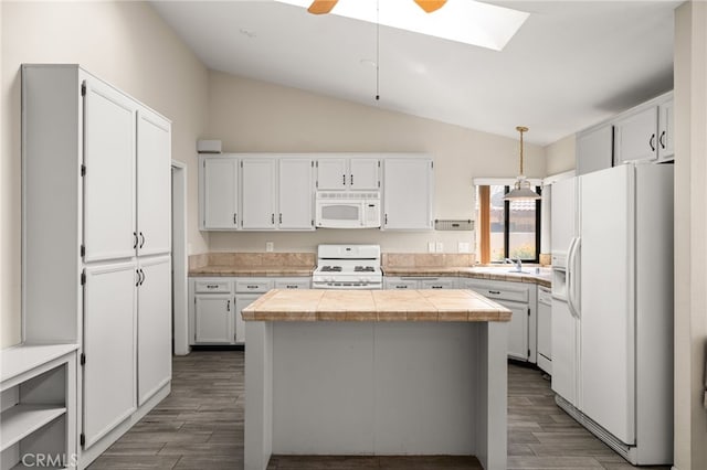 43922 Warner Trl, Palm Desert, CA 92211 - kitchen featuring white appliances, vaulted ceiling, a kitchen island, a skylight, and dark wood-style floors