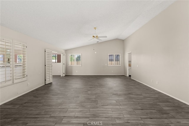 unfurnished living room with baseboards, a ceiling fan, dark wood finished floors, and vaulted ceiling