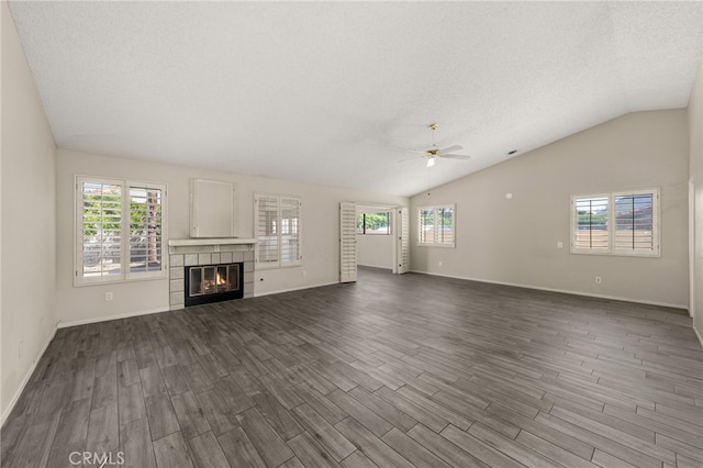 43922 Warner Trl, Palm Desert, CA 92211 - unfurnished living room with a ceiling fan, healthy amount of natural light, dark wood finished floors, vaulted ceiling, and a textured ceiling