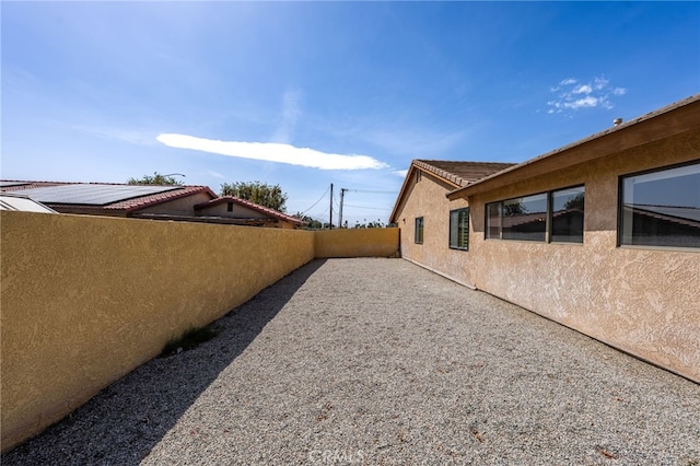 43922 Warner Trl, Palm Desert, CA 92211 - view of side of home with stucco siding, fence, and a patio area