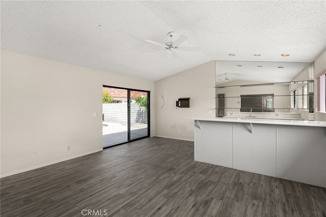 kitchen featuring dark wood-style flooring, a textured ceiling, and open floor plan