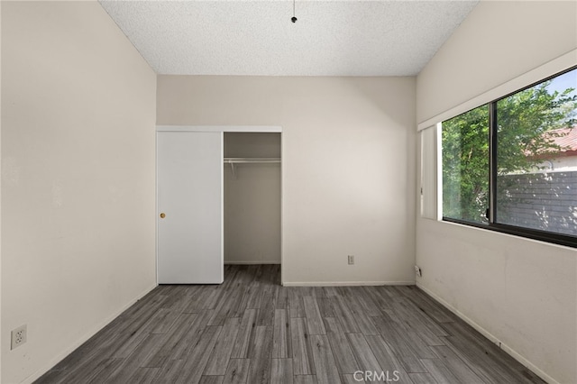 43922 Warner Trl, Palm Desert, CA 92211 - unfurnished bedroom with wood finished floors, a closet, a textured ceiling, and baseboards