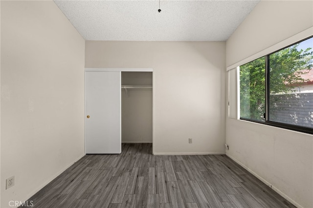 43922 Warner Trl, Palm Desert, CA 92211 - unfurnished bedroom with wood finished floors, a closet, and a textured ceiling
