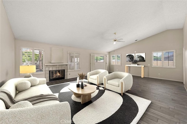 43922 Warner Trl, Palm Desert, CA 92211 - living area featuring vaulted ceiling, wood finished floors, healthy amount of natural light, ceiling fan, and a tile fireplace