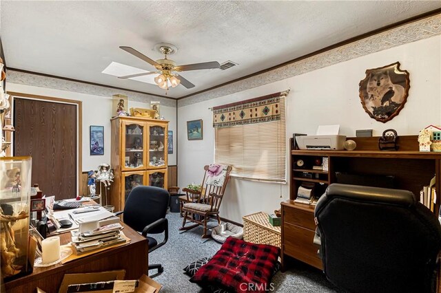 carpeted office featuring crown molding, a ceiling fan, a textured ceiling, and visible vents