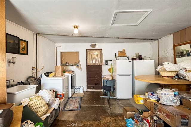 interior space featuring freestanding refrigerator, unfinished concrete flooring, and washer and clothes dryer