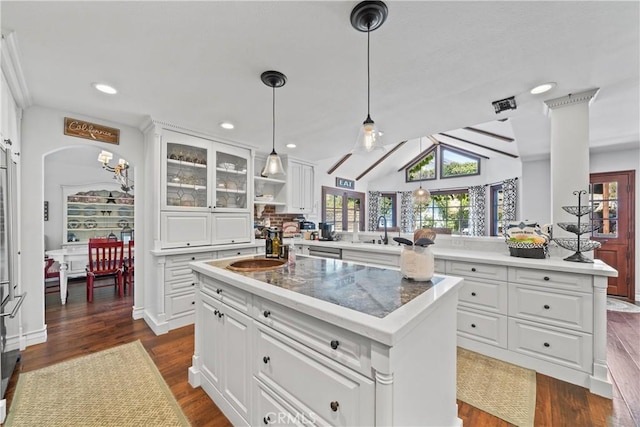 kitchen with a kitchen island, dark wood-style flooring, plenty of natural light, and a sink