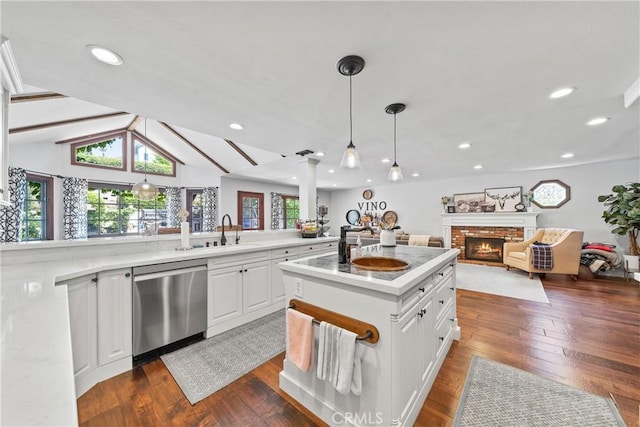 28102 Camellia Ct, Laguna Niguel, CA 92677 - kitchen with stainless steel dishwasher, a sink, open floor plan, white cabinetry, and dark wood-type flooring