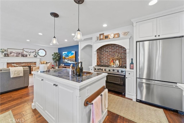 kitchen featuring a sink, white cabinetry, a kitchen island, and stainless steel appliances