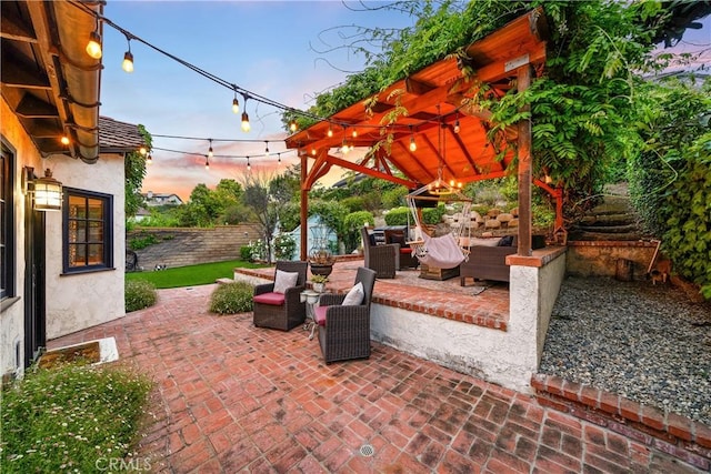 patio terrace at dusk with a fenced backyard and an outdoor living space
