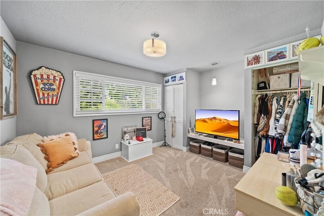 living room featuring baseboards, a textured ceiling, and carpet floors