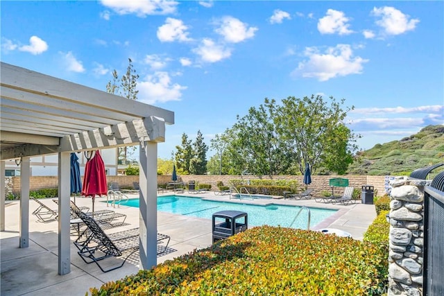pool with a pergola, fence, and a patio