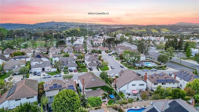 aerial view at dusk featuring a residential view