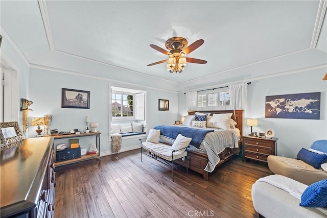 bedroom with multiple windows, wood-type flooring, a tray ceiling, and ceiling fan