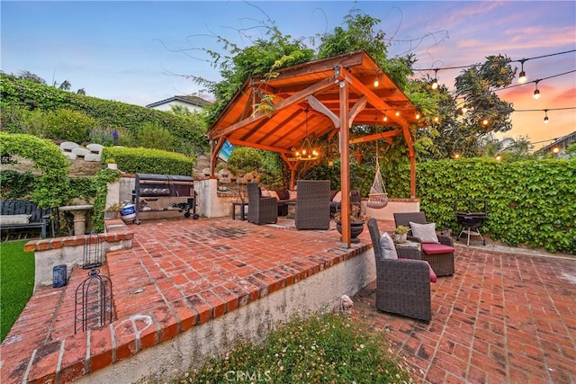 patio terrace at dusk featuring a gazebo