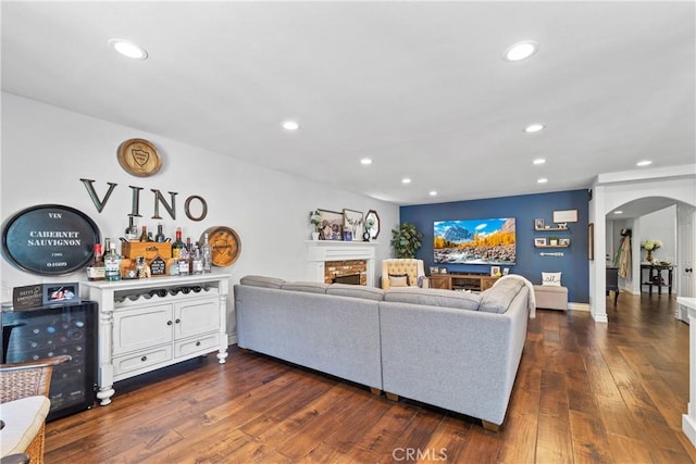 28102 Camellia Ct, Laguna Niguel, CA 92677 - living room with arched walkways, recessed lighting, dark wood finished floors, and a fireplace