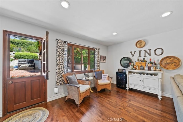 living area with plenty of natural light, a dry bar, dark wood-style floors, and recessed lighting