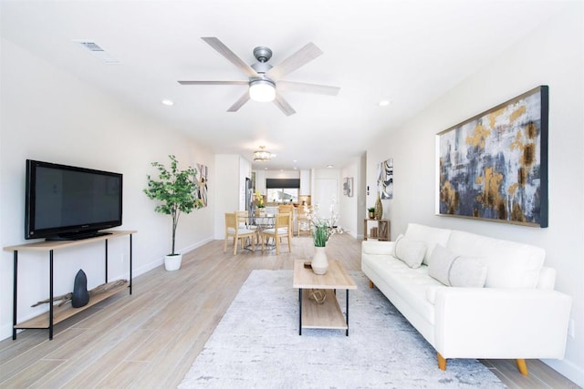 living area with light wood-style floors, ceiling fan, recessed lighting, and visible vents