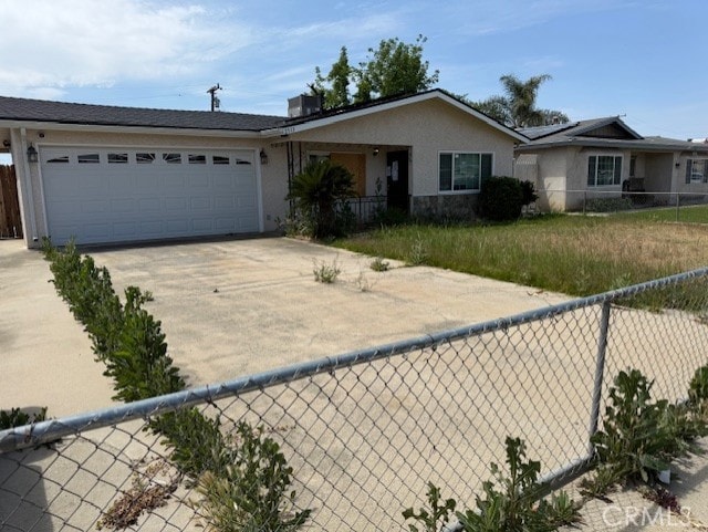 ranch-style home with fence, stucco siding, driveway, and a garage