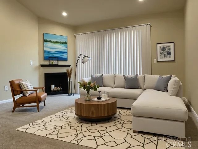 living area featuring baseboards, a fireplace, recessed lighting, and light colored carpet