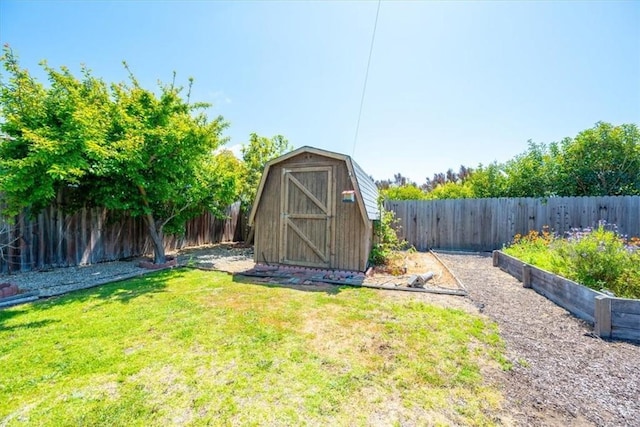 view of shed featuring a fenced backyard and a vegetable garden