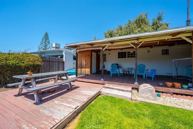 back of house featuring fence and a deck